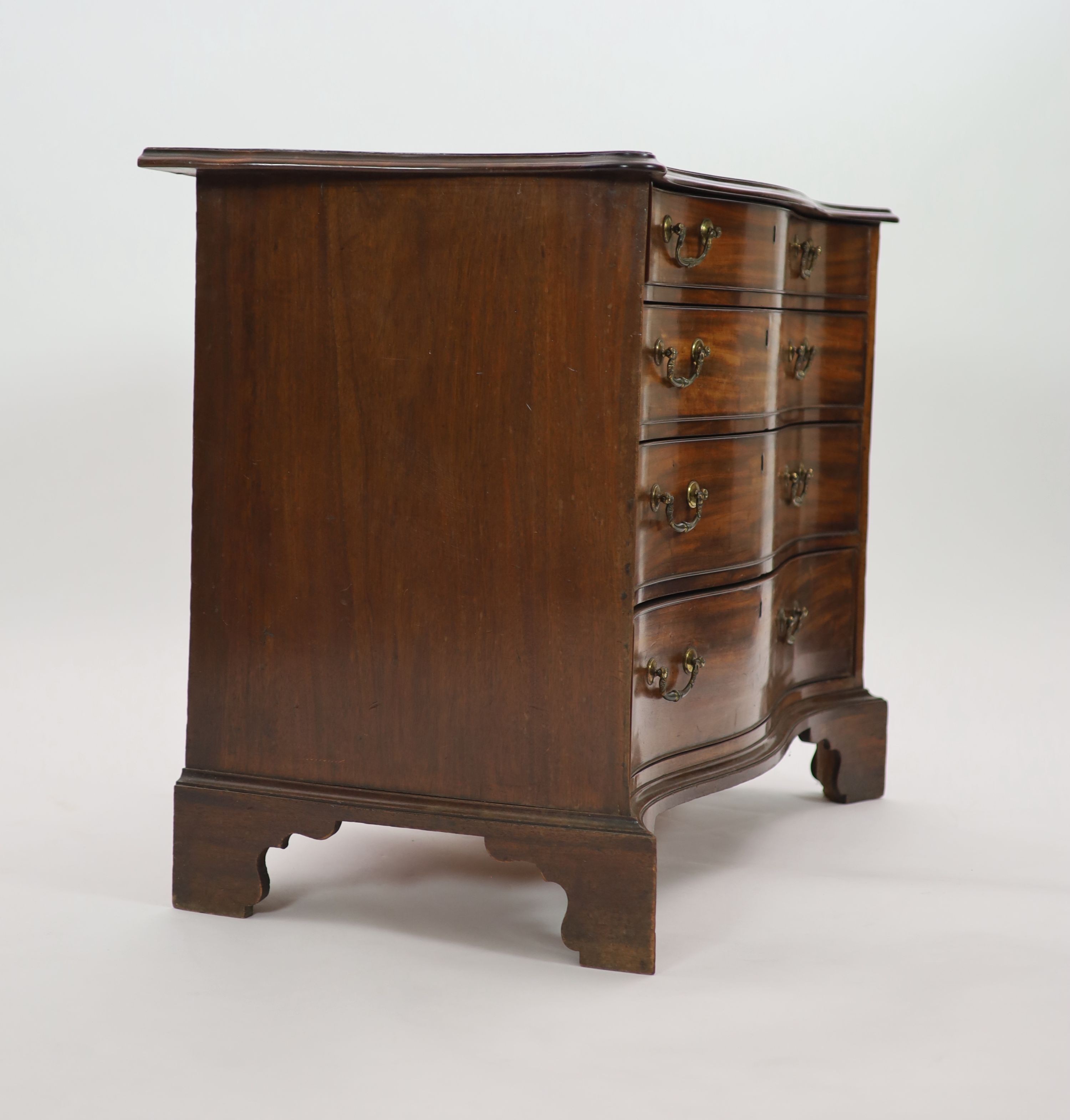 A George III serpentine mahogany chest, W.111cm D.55cm H.81cm